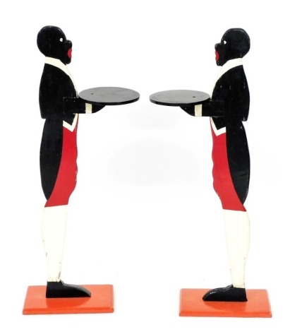 A pair of 20thC dumb waiters, modelled as black serving waiters, painted in black, white, and red, 88cm high.