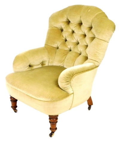 A Victorian mahogany arm chair, upholstered in button back green draylon, raised on turned legs on castors, 65cm wide.