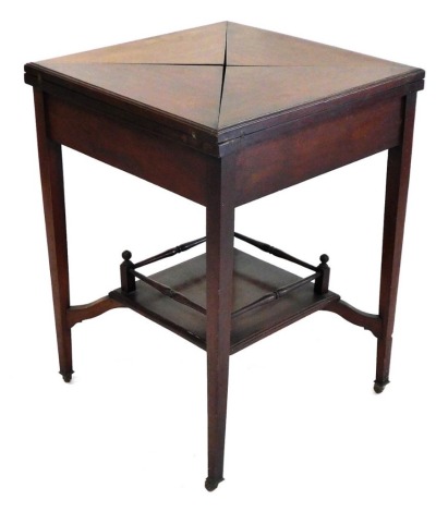 A Victorian mahogany envelope fold over card table, with a gilt tooled baize interior, over a frieze drawer, raised on tapering square legs united by a galleried under tier, brass capped on castors, 74cm high, 55cm wide, 55cm deep.