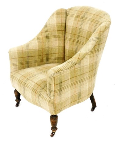 A Victorian mahogany armchair, upholstered in striped Harris tweed fabric, raised on turned legs, brass capped on castors, 64cm wide.