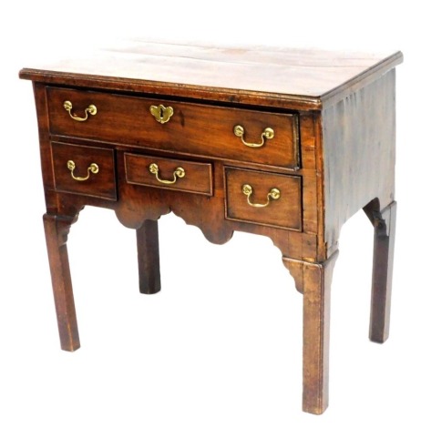 A George III mahogany low boy, with one long over two deep and one short drawer, over a shaped apron, raised on square legs, 71cm high, 75cm wide, 45cm deep.