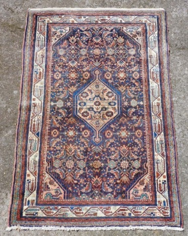 A Persian Koliai brown ground rug, decorated with a central floral medallion, and further smaller medallions, and flowers and botehs, within repeating geometric borders, 158cm x 107cm.