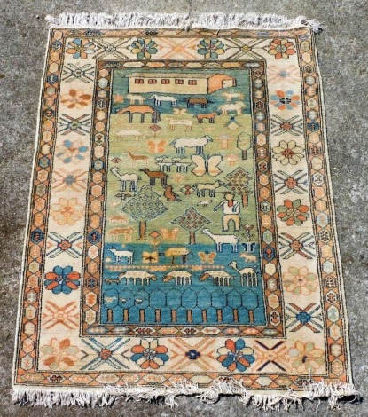 A wool rug, the rectangular central reserve decorated with figures, domestic animals, butterflies, and flowers, and a homestead, within a repeating floral and geometric borders, 166cm x 124cm.