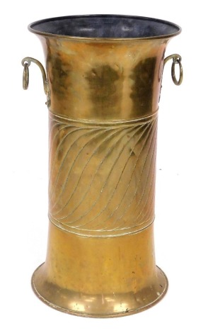 A Victorian Arts and Crafts brass twin handled stick and umbrella stand, with a spiral engraved central band, 60cm high.