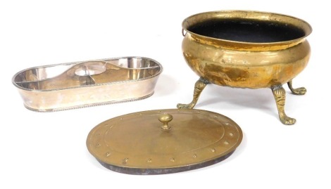 A Victorian oval brass coal bucket, raised on four paw feet, 37cm wide, a brass lid, 41cm wide, and a silver plated wine bottle holder, of oval four section form, with a gadrooned border, 45.5cm wide. (3)