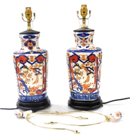 A pair of Chinese Imari porcelain table lamps, decorated with panels of birds and flowers, raised on wooden bases, 54cm high. Buyer Note: WARNING! This lot contains untested or unsafe electrical items. It is supplied for scrap or reconditioning only. TRAD