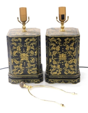 A pair of Chinese black lacquer table lamps, of canted rectangular form, painted with flowers and scrolling leaves, 39cm high.