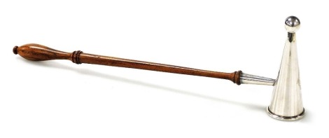 An Elizabeth II candle snuffer, with a turned wooden handle, David Shaw Silver Ware Ltd, London 1979, 25.5cm long.