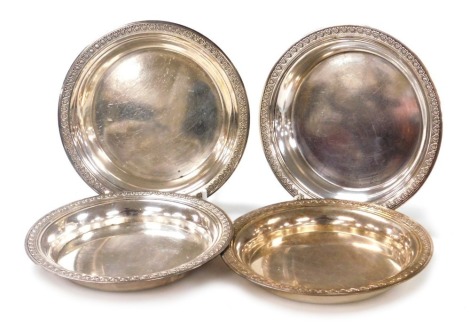 A set of four Christofle silver plated dishes, each with a repeat patterned border, marked to underside Christofle 5, 15.5cm diameter.