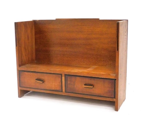 An Art Deco oak book shelf, with ebony trim, having two frieze drawers, 37.5cm wide.