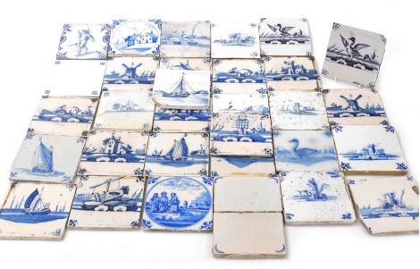 A group of 18thC and later Delftware blue and white tiles, decorated with windmills, houses, figures, birds, and animals. (a quantity)