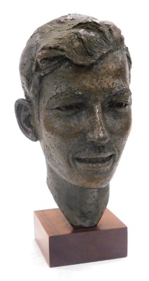 A 20thC hollow cast bronze bust of a gentleman, raised on a wooden base, 35cm high.