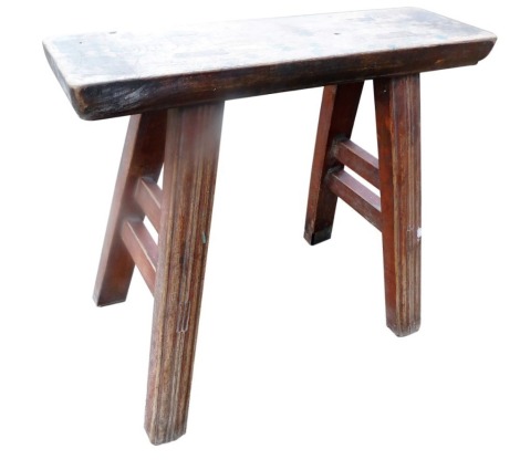 A late 19th/early 20thC Chinese elm stool, with a rectangular plank top, on channelled legs with stretchers, 44cm high, the seat 49cm wide. (AF)