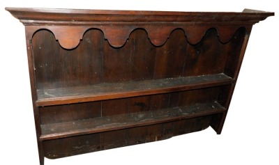 An early 19thC oak and mahogany cross banded dresser, the base with an arrangement of five drawers and two doors, with raised panels, flanked by rounded pilasters, on ogee bracket feet, with an associated plate rack, the base 89cm high, 152cm wide, 44cm d