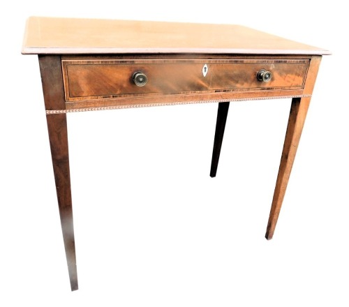 An early 19thC mahogany boxwood strung and chequer banded side table, the rectangular top with a moulded edge above a single frieze drawer with brass handles, on square tapering legs, 62cm high, 69cm wide, 43cm deep.