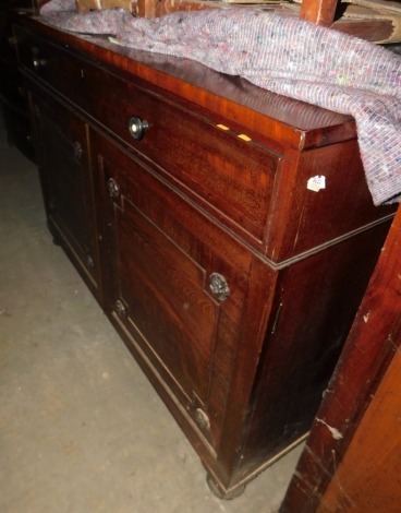 A 19thC mahogany secretaire cabinet, of plain form with a frieze drawer, fitted with hinged compartments, a pen tray, space for inkwells, and an adjustable writing slope with brown leatherette insert, above two panelled doors, each with floral patera encl