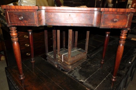 A 19thC inverted breakfront side table, with a shaped top above three frieze drawers, two with turned wooden handles, on turned tapering legs, 81cm high, 104cm wide, 49cm deep.