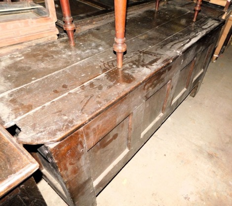 A large late 17th/early 18thC oak coffer, with a planked top enclosing a vacant interior with single later division, the front with four panels, on stiles, 80cm high, 175cm wide, 60cm deep. (AF)