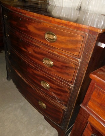 A late George III mahogany bow fronted chest of drawers, with an arrangement of four graduated drawers, each with oval brass drop handles, flanked by reeded sides, on splayed bracket feet, 110cm high, 120cm wide, 56cm deep.