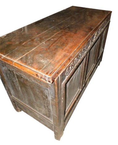 A late 17th/early 18thC mule chest, the plank top with a moulded edge above a carved frieze, bearing initials TC and bearing date 1711, above three panels and a drawer, on stiles, 80cm high, 124cm wide, 53cm deep.