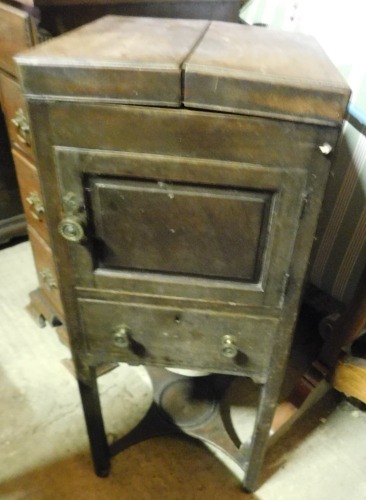 A George III mahogany enclosed washstand, the hinged top reveal a recess for a bowl, two beakers and an adjustable mirror, above a panelled door and a drawer, on chamfered legs with concave under tier, 90cm high, 38cm wide when enclosed.