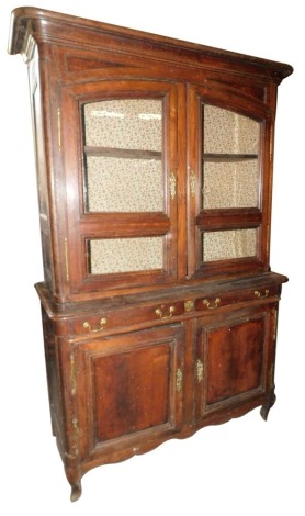 A 19thC French chestnut dresser, the top with a moulded cornice, above two doors with shaped glazed panels enclosing two shelves, the base with two frieze drawers above two panelled doors, each with brass hinges and escutcheons, on scroll carved feet, 231