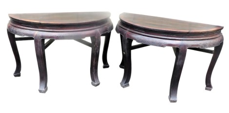 A pair of late 19th/early 20thC Chinese elm demi lune side tables, each with a moulded frieze, carved with stylised Greek key and scrolls, on splayed legs, 86cm high, 131cm wide, 65cm deep.