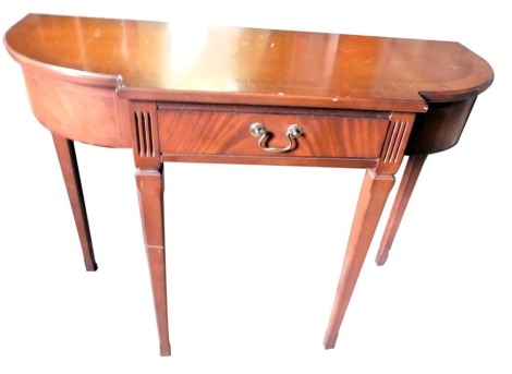 A mahogany breakfront side table, the shaped top above a single frieze drawer, flanked by bowed sides, on square tapering legs, 96cm wide.