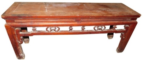 A late 19th/early 20thC Chinese elm low table or bench, of rectangular form, with pierced and carved frieze, on shaped legs, 50cm high, 116cm wide, 32cm deep.