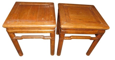 A pair of Chinese occasional tables, each with a square panelled top and a pierced and shaped frieze, on shaped legs, 52cm high, 48cm wide.