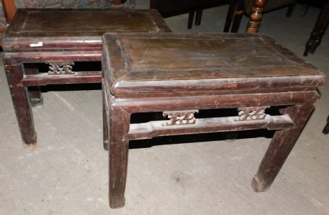 A pair of late 19th/early 20thC Chinese elm rectangular low tables, each with a pierced and carved frieze, and shaped legs, 48cm high, 58cm wide, 32cm deep.