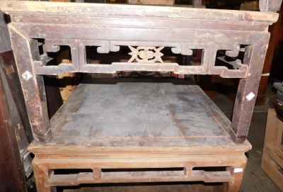 A Chinese elm low or coffee table, with a pierced carved frieze, on shaped supports, 52cm high, 86cm wide. (AF)