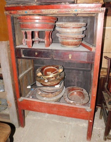 A 19th Chinese red gilt cabinet, the carved frieze inset with glass cabochon, the interior with two drawers on plain supports, one door, 174cm high, 111cm wide.