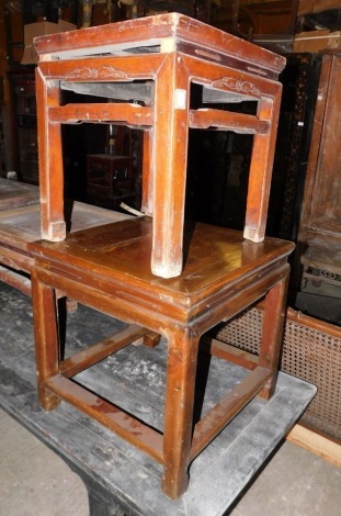 Three various Chinese elm low tables, each with square top shaped frieze and legs, the smallest 44cm wide, the largest 52cm wide.