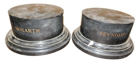 A pair of cylindrical black marble plinth, engraved Reynolds and Hogarth respectively, 14cm high, 27cm diameter respectively.