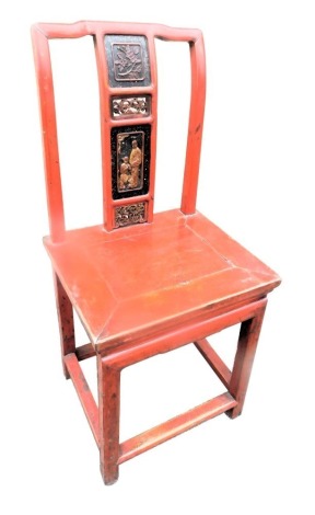 A small Chinese red lacquer side chair, the back applied with panels of figures, flowers, etc., with a solid seat, on plain legs.