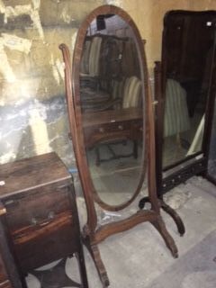 A late 19th/early 20thC mahogany boxwood strung and chequer banded cheval mirror, with an oval plate, on shaped supports with splayed legs and castors, 174cm high, 67cm wide.