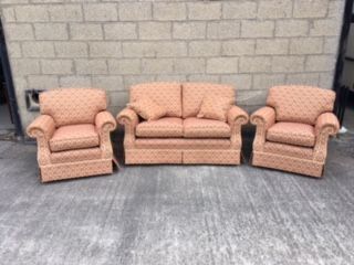 A three piece lounge suite, comprising sofa, two armchairs, each with gold and red pattern fabric, with rope borders. Ex Mitchells Interior sale 17062021 lot 542.