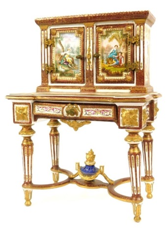 A 19thC Continental miniature porcelain Bonheur du jour, with painted panels, depicting figures, animals and buildings, with a panel to back stamped Offert Parle Marquis Ole Sillette A Pa Princesse De Lamballe, signed A C with gilt star symbol, 37cm high,