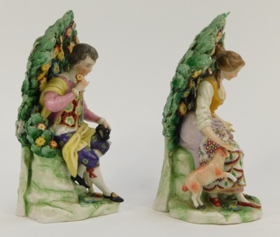 A pair of Continental Derby style porcelain figure groups, of lady and gentleman seated on perch with floral spray back, red crown stamp to underside, 15cm high. - 4