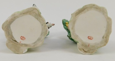 A pair of Continental Derby style porcelain figure groups, of lady and gentleman seated on perch with floral spray back, red crown stamp to underside, 15cm high. - 5