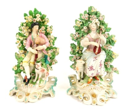 A pair of 19thC Continental porcelain figure groups in Derby style, depicting male and female playing musical instruments, bagpipes and banjo, on scroll painted base, unmarked, 20cm high.