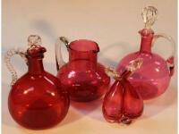 Two cranberry glass decanters with clear glass stoppers