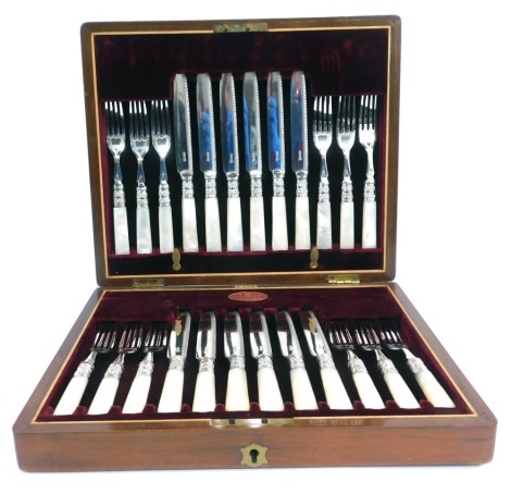 A set of late Victorian silver plated dessert knives and fork, with mother of pearl handles, in a fitted walnut case with red plush lining and retail label for Daniel Todd & Son, Argyle Arcade, Glasgow.