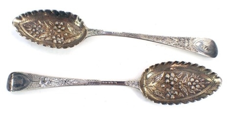 A composite pair of Georgian silver berry spoons, with swan crests and with later decoration of flower heads and foliage, with repousse bowls, London 1808 and 1815, one spoon by William Eley, 4oz.