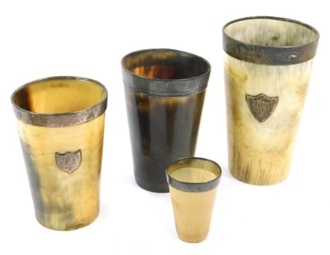 Four horn and silver rimmed beakers, two bearing crest for H J and G & H S, the largest 10cm high, the smallest 4cm high. (4)