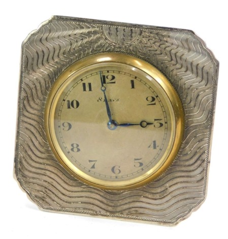 A white metal framed strut clock, of square form with waved sun design and brass central eight day clock, unmarked, 6.5cm x 6.5cm.