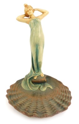 An early 20thC Art Nouveau Bernard Bloch pottery figure, of a standing lady atop a scallop shell, designed by R Dubitzky, model number 6246, impressed marks, 30cm high.