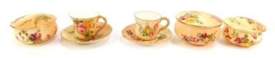 A group of Royal Worcester blush porcelain, comprising two miniature coffee cups and saucers, and three dressing table circular boxes and covers, all painted with floral sprays. (5)