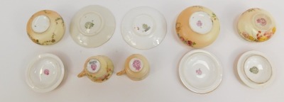 A group of Royal Worcester blush porcelain, comprising two miniature coffee cups and saucers, and three dressing table circular boxes and covers, all painted with floral sprays. (5) - 3